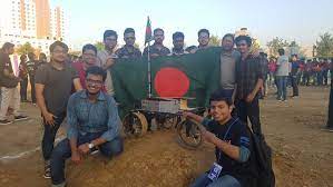 Robotics team holding the Bangladesh flag outdoors