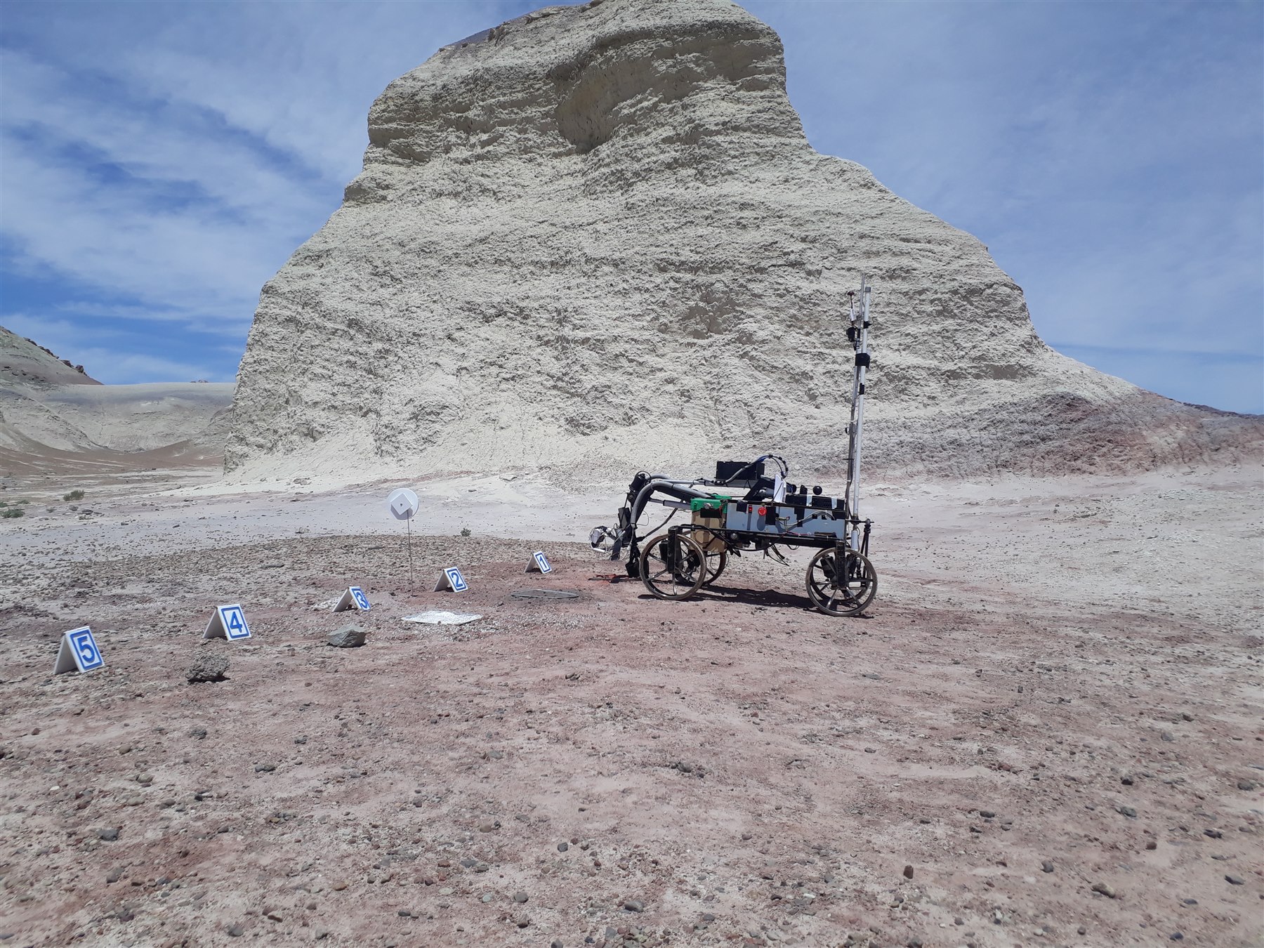 Mongol Tori rover beside a large rock formation